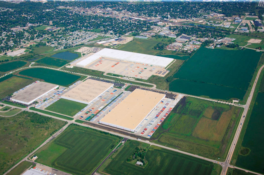 Crossroads 55 park with multiple buildings and green fields, aerial