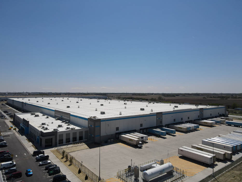 Gateway 57 distribution center with white roof and docks, by Venture One