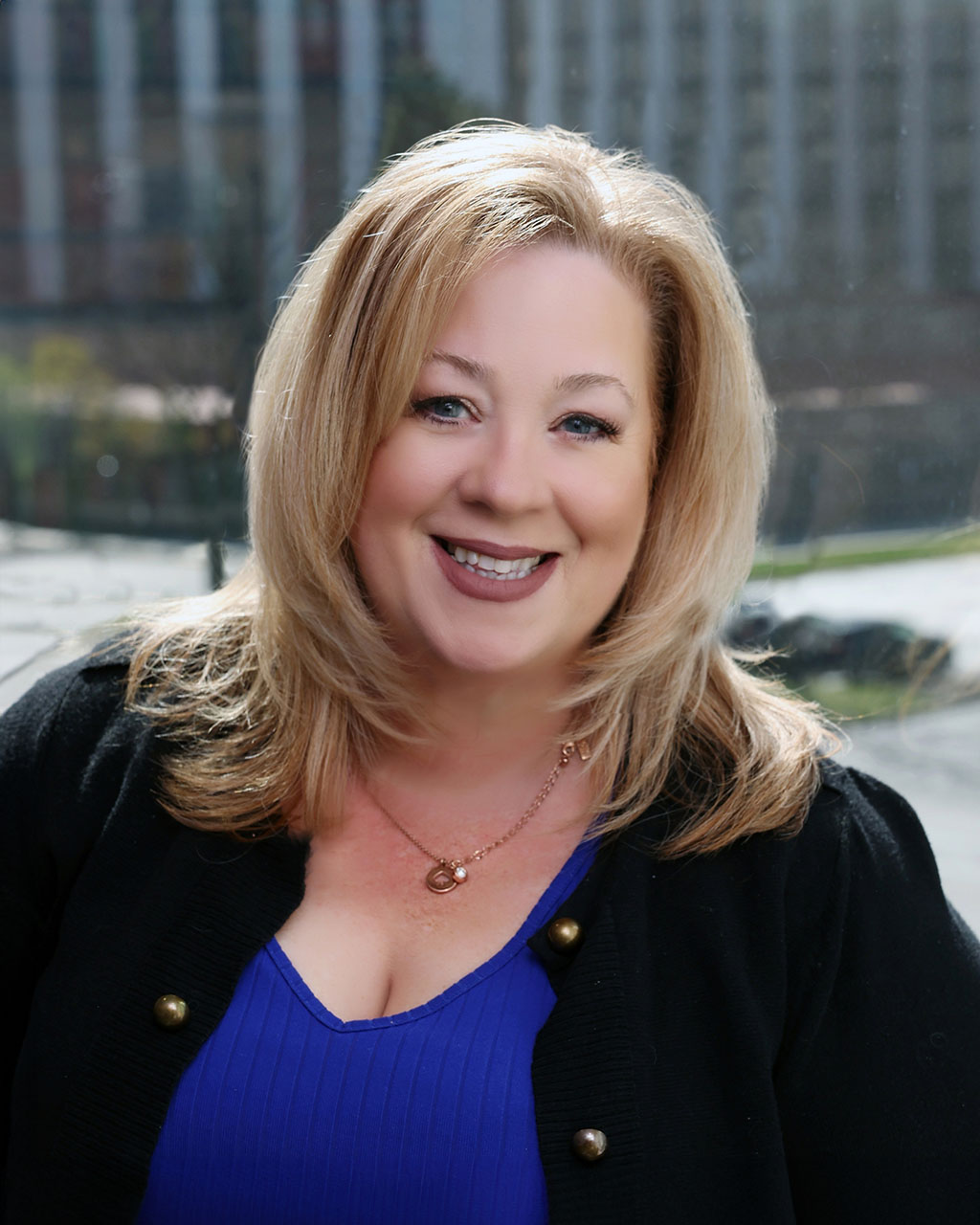 Pam Newford, Venture One industrial real estate expert, smiling outdoors